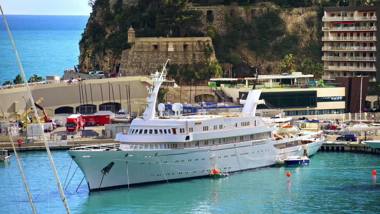 White yacht docked in the Monaco Marina in daylight