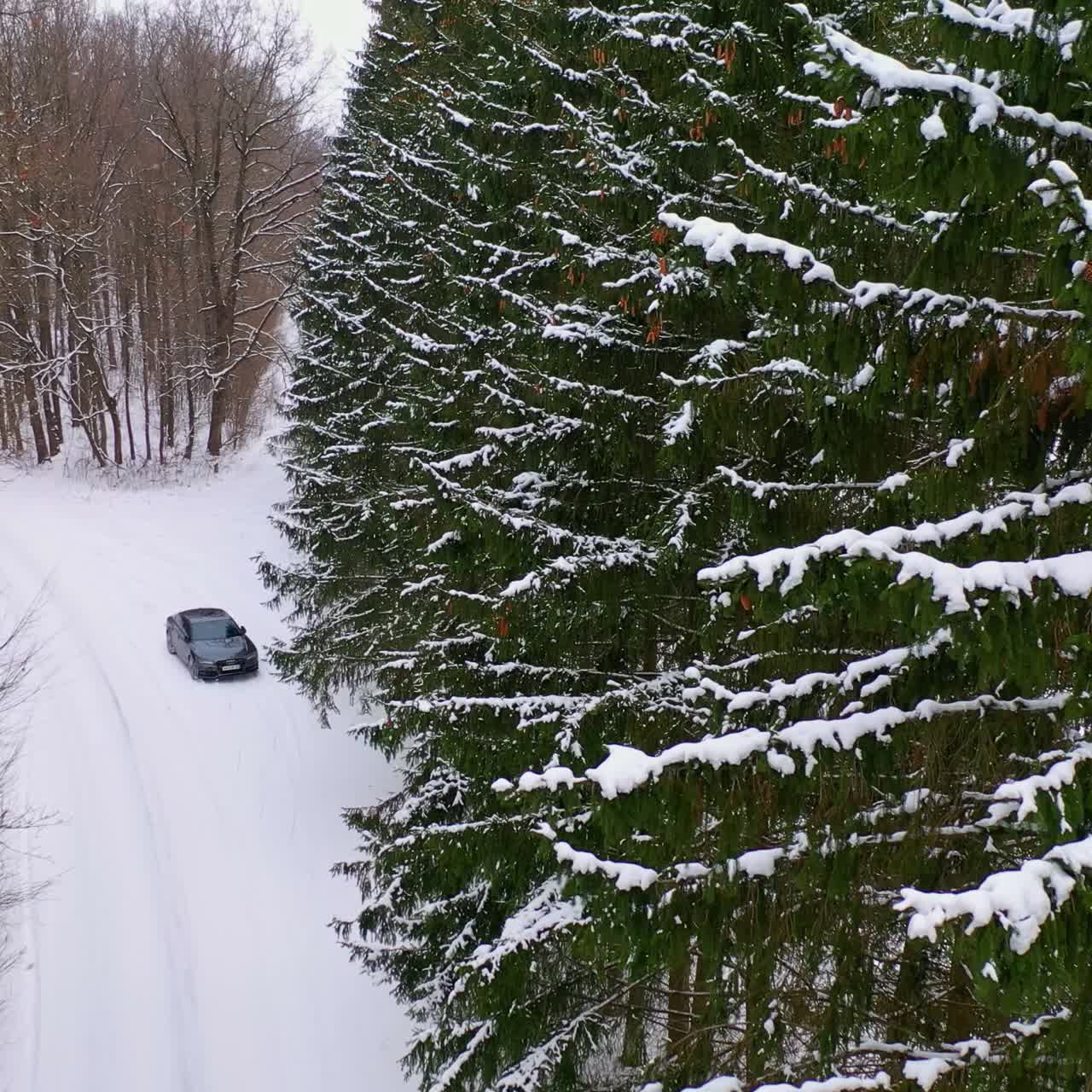 Drone view of car on winter road