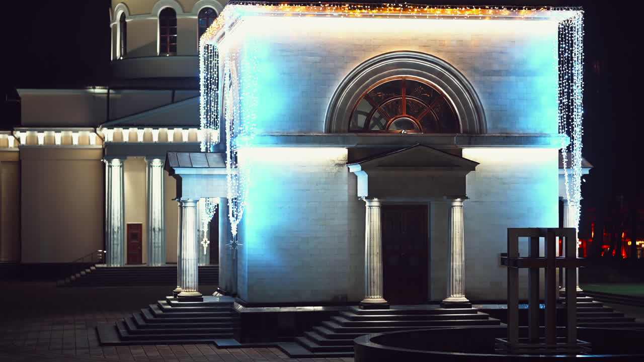 Chisinau, Moldova - December 20, 2021: The bright lights accentuate the architecture of a building during nighttime, creating a captivating atmosphere. Surrounding features add to the overall elegance of the location