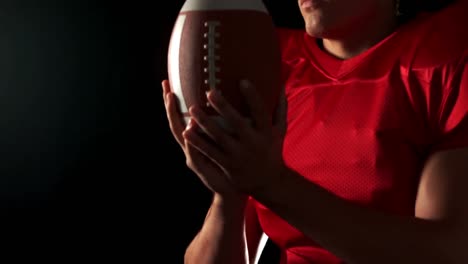 american footblall player holding ball