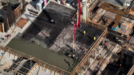 construction workers during concrete pouring at the construction site in vancouver, canada