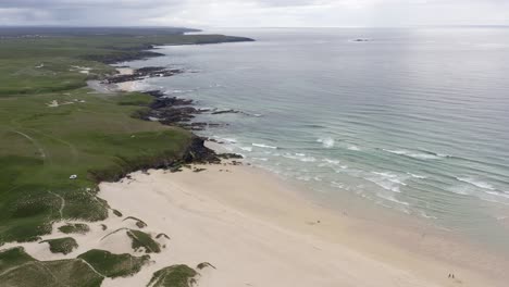 drone shot of eoropie beach in ness and the coastline beyond it on a sunny, summer's day