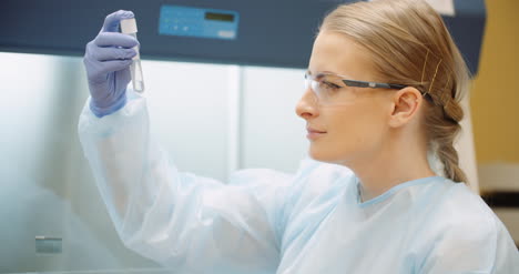 scientist analyzing tubes at laboratory 1