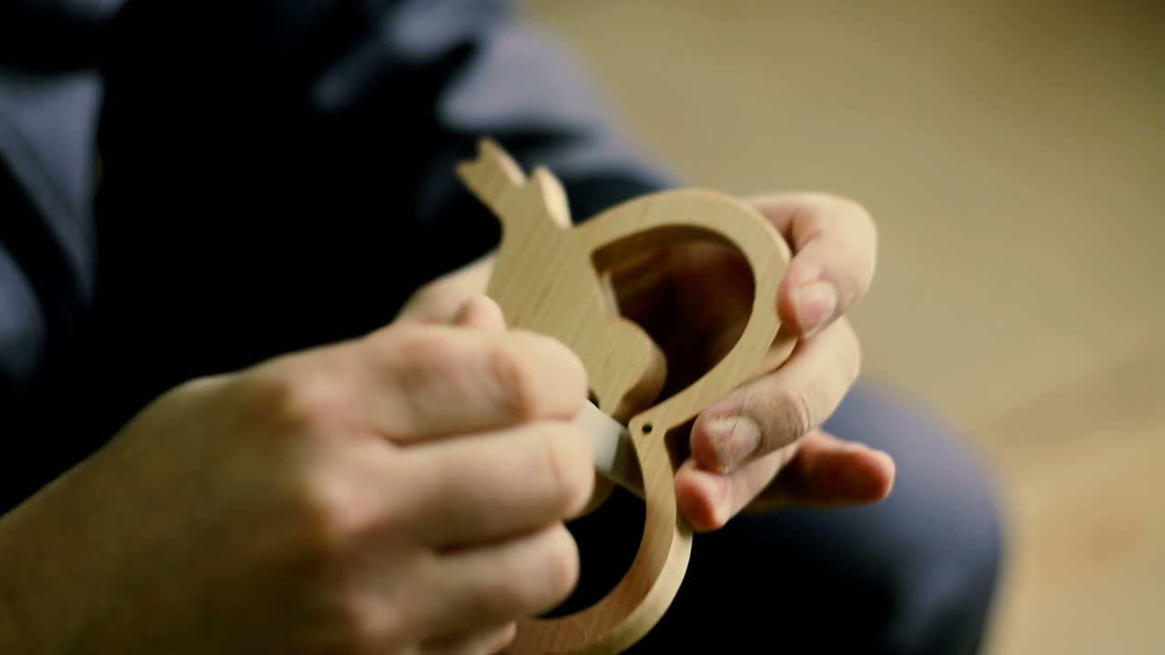 Carpenter Sanding Furniture. Close-up of male carpenter sanding wood in his workshop
