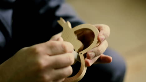 carpenter sanding furniture. close-up of male carpenter sanding wood in his workshop