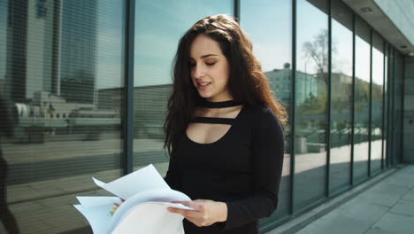 happy woman celebrating victory in black dress outdoors