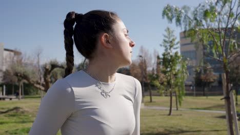 young athlete performing warm-up exercises in park