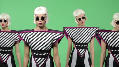 four women in futuristic costumes performing dance