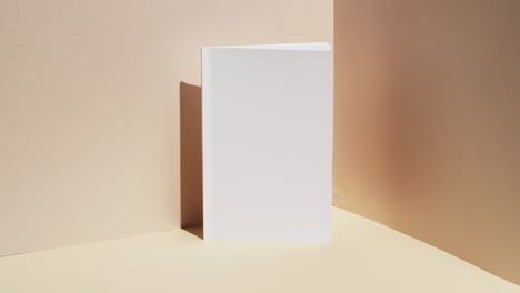 video of book with white blank pages and copy space on yellow background