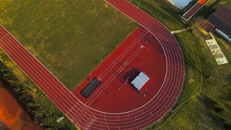 aerial 4k drone footage of outdoor sports complex and the group of people involved in physical activity