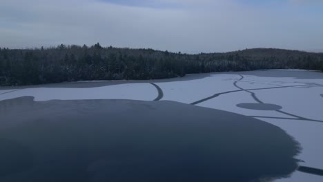 winter aerial of lake clermoustier blanketed in snow and ice, petit-chertsey