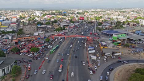 aerial birds eye shot of traffic in city of santo domingo at sunset time. busy rush hour time on dominican republic. establishing shot.