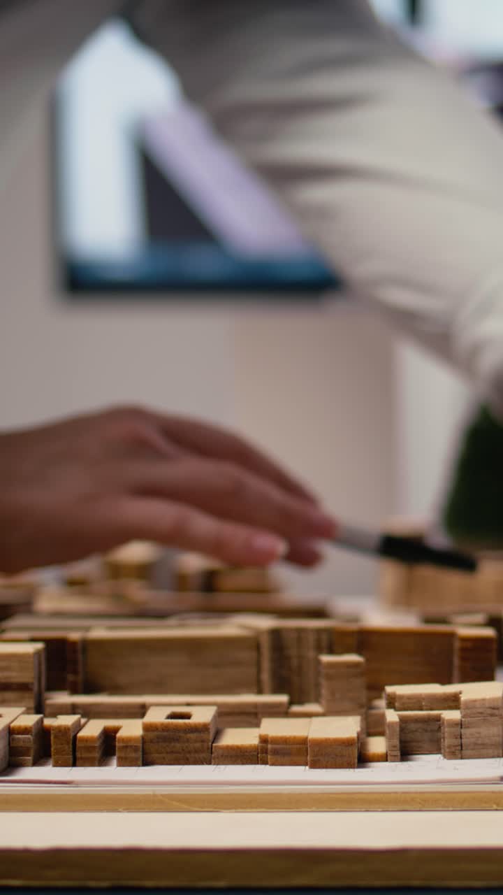 Vertical Video Close up of diverse developers focuses on 3D models layout presentations