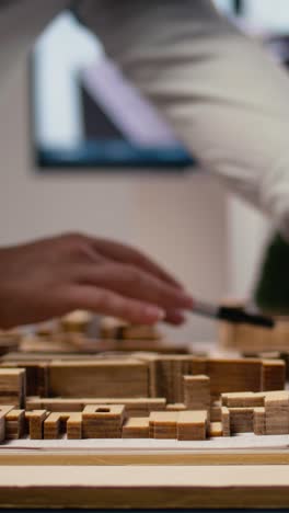 vertical video close up of diverse developers focuses on 3d models layout presentations