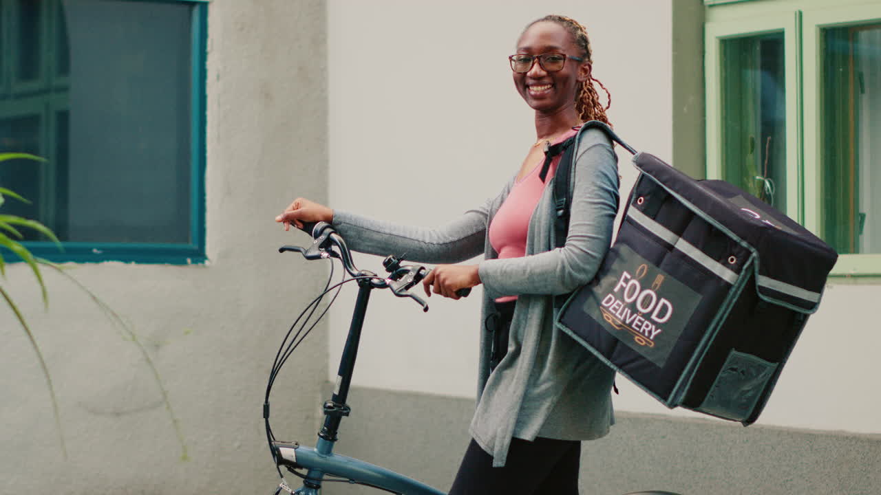 Woman on bicycle with food delivery bag