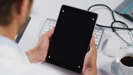 Caucasian-male-doctor-having-video-call-consultation-using-tablet-computer