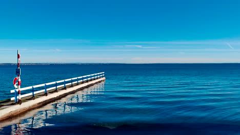 boardwalk-on-empty-beach-near-calm-ocean