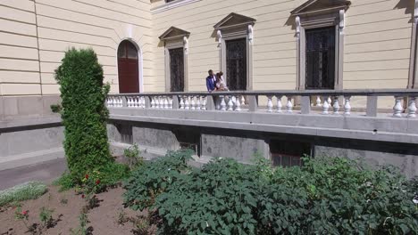 romantic sensual moment. aerial shot of a happy newlywed couple leaning on balcony in honeymoon