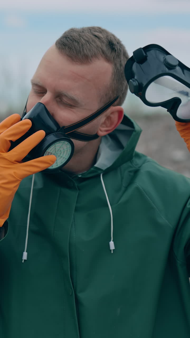 Apocalypse man with gas mask in ruins. Portrait of man in the gas masks and protective clothes on the ruined background