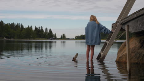 Blonde-child-wade-in-high-tide-water