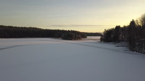 Frozen-lake-in-Falun,-Sweden-during-a-cold-winter-in-December,-filmed-with-a-drone