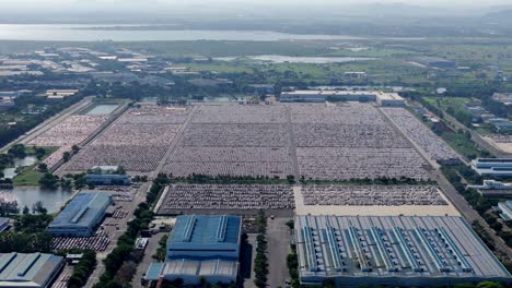 rows of many cars in the largest parking lot, hyundai motor india limited car manufacturing plant in sipcot industrial park, chennai, tamil nadu, aerial view