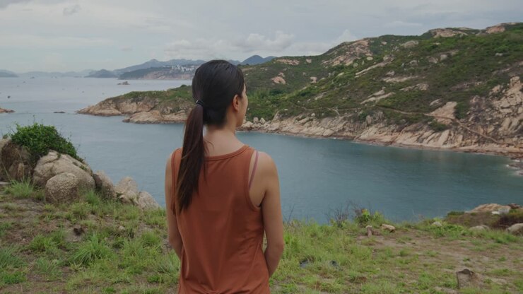 Rear view of a woman enjoying the seascape
