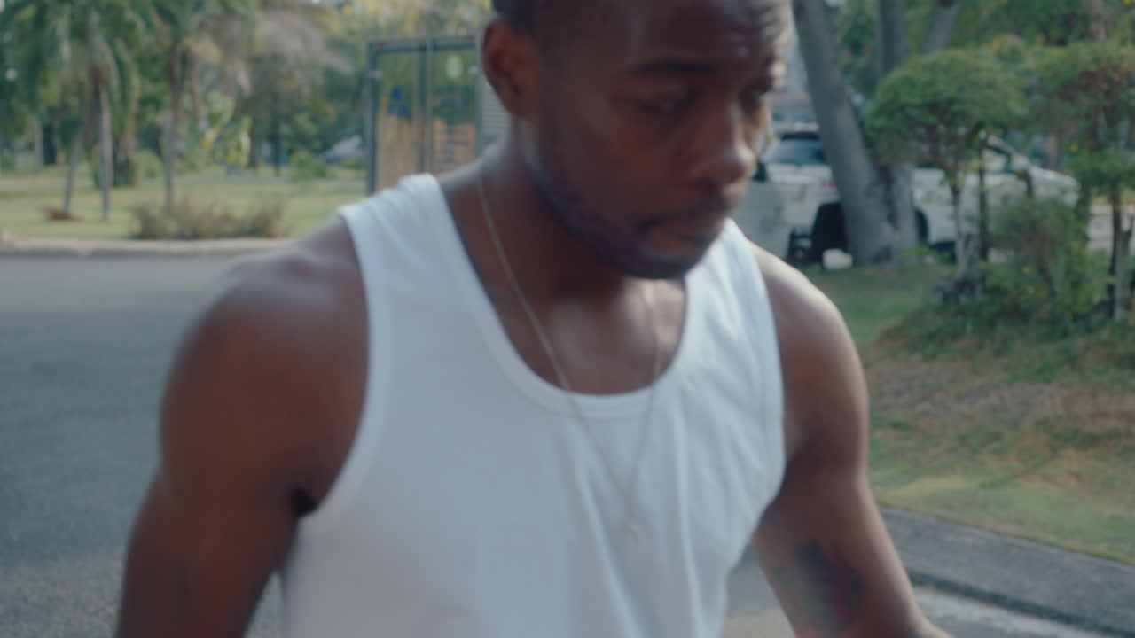 Young Black Sportsman Dribbling Basketball on Outdoor Playground