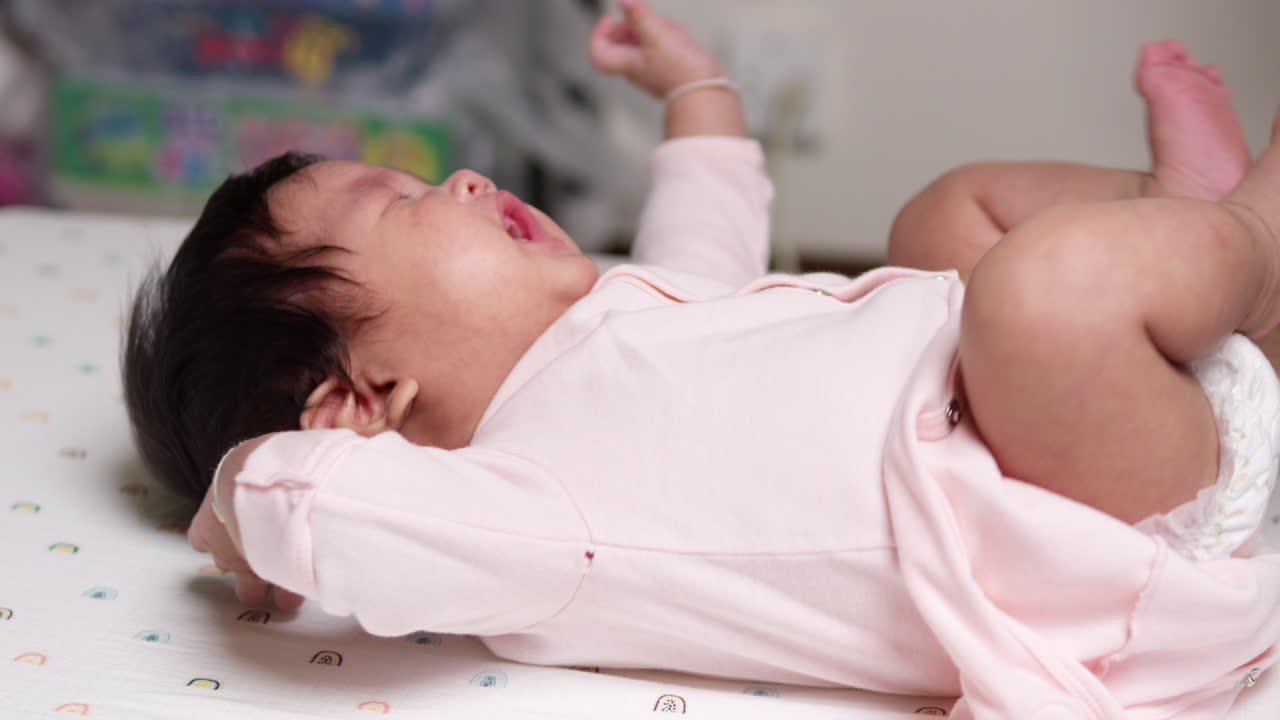 Caring new mom diligently checking and changing her baby's diaper, embodying the essence of patience and the joys of motherhood. A heartwarming moment captured