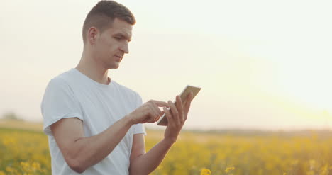 -Agriculture-Technology-Farmer-Using-Digital-Tablet-On-Agricultural-Field-