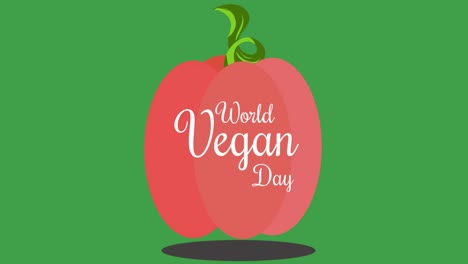 animación de la ilustración del texto del día mundial vegano en blanco sobre una manzana roja, sobre un fondo verde