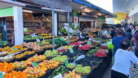 vibrant market scene with diverse fruits and shoppers