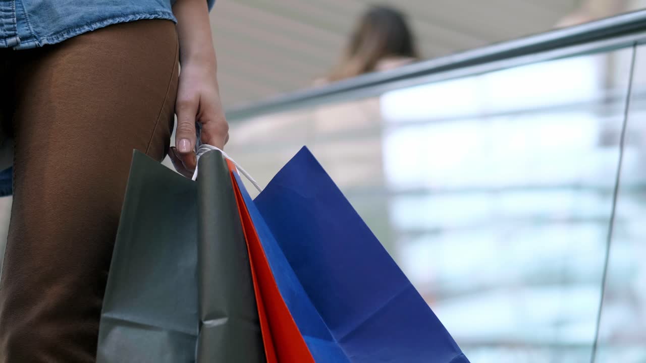 Close up of woman's hand with full shopping bags