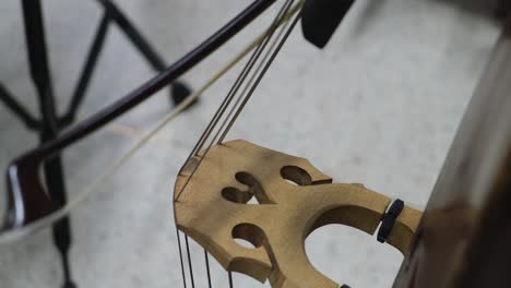 Double-Bass-Player-bowing-his-instrument-during-a-rehearsal,-Beginning-Orchestra