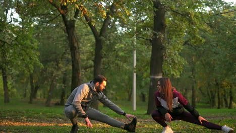 couple stretching in the park