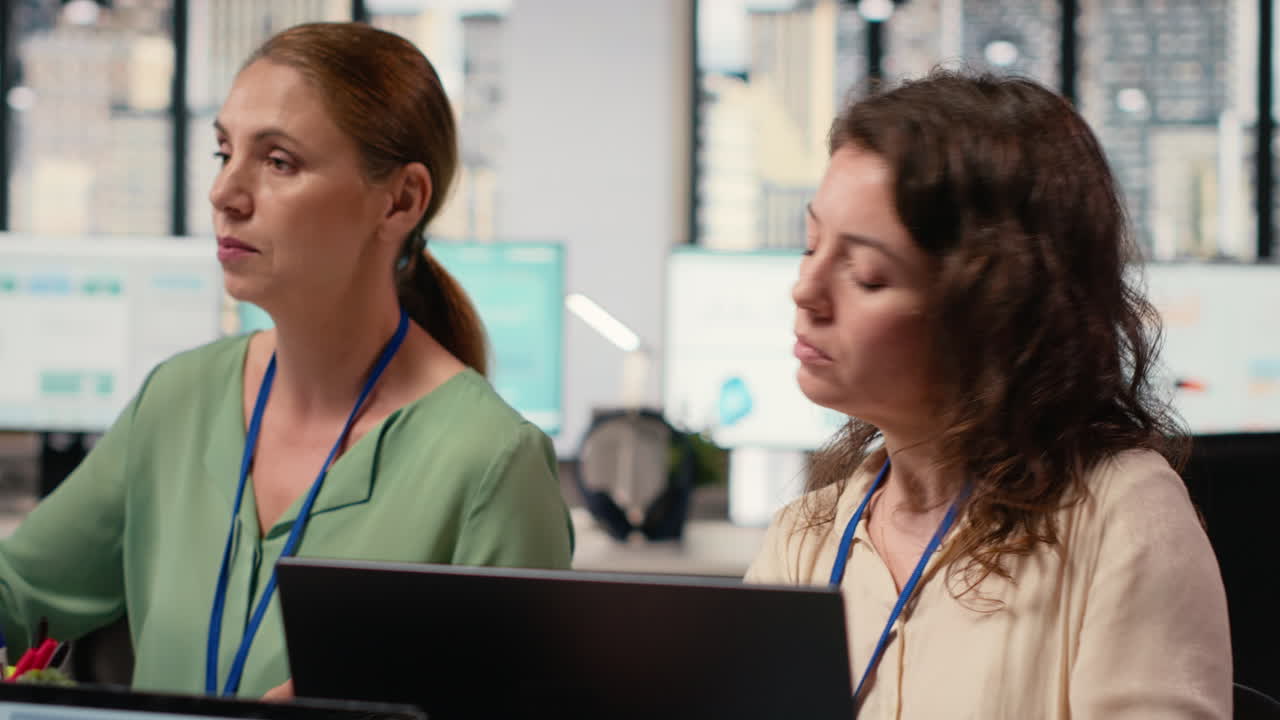 Vertical Video Ambitious woman works at workstation during meeting with colleagues