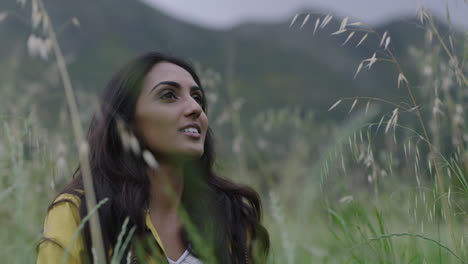 beautiful young indian woman hiker enjoying fresh breeze blowing smiling calm looking at nature independent female hiking alone on travel adventure