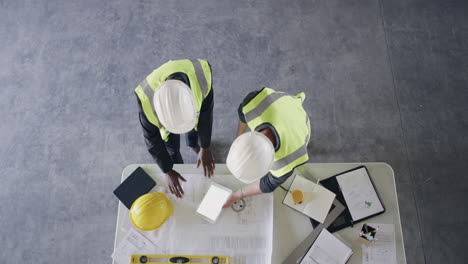 two-engineers-looking-at-something-on-a-digital