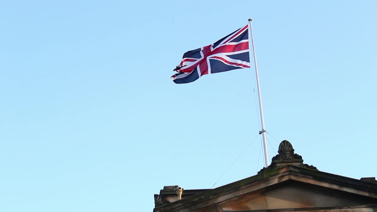Union Jack waving above an old building