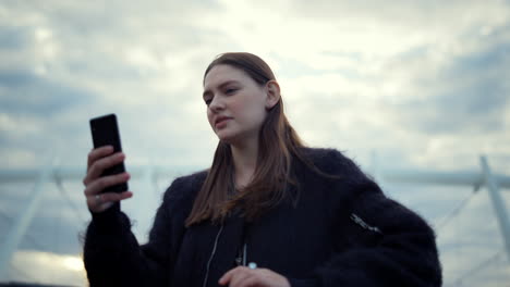 woman using smartphone for video call. girl talking with friend by video chat