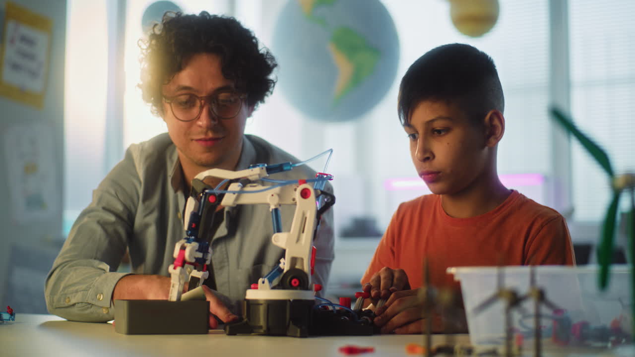Teacher and Student Building a Robotic Arm