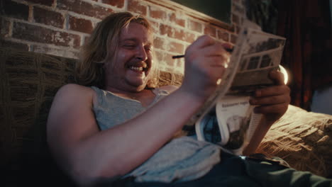 man solving a puzzle on a couch