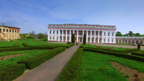 museum ensemble of well-repaired building and two old bad-looking parts. palace in ukrainian town of tulchyn in midday.