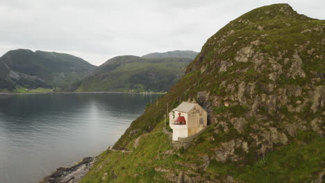 hendanes lighthouse in vagsvag region near maloy at the coast of norway - aerial drone shot