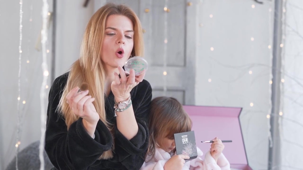 little daughter with mom doing makeup