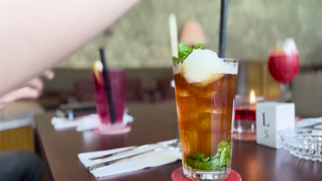 putting straw into iced lychee tea summer refreshing drink