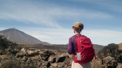 A-tourist,-young-woman-admires-a-deserted-mountain-landscape-in-Tenerife,-Canary-Islands