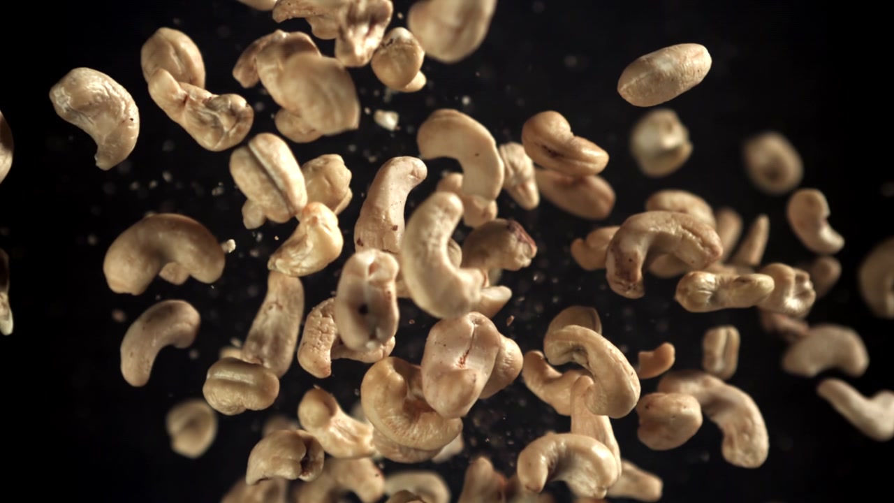 Cashew Nuts Falling in Slow Motion on Black Background