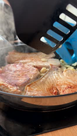 cooking pork chops in a frying pan