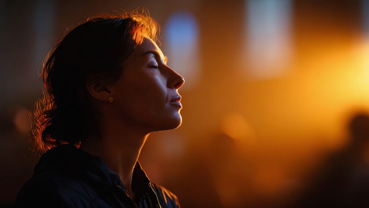 A serene moment of introspection captured in soft light, revealing a woman's peaceful expression amidst a warm, golden ambiance, perfect for conveying tranquility and reflection